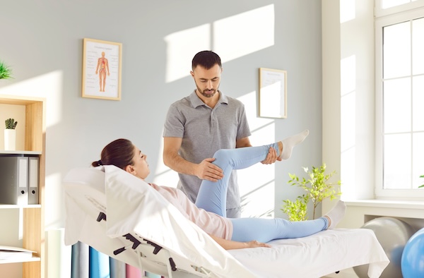 Male,Chiropractor,Or,Physiotherapist,Working,With,Female,Patient.,Man,Doctor Understanding the Symptoms, Causes, and Treatments for Spinal Stenosis